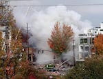 Smoke rises as firefighters battle a blaze after a gas explosion in Portland, Ore., Wednesday, Oct. 19, 2016. 