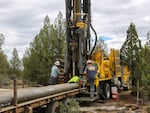 Drillers work to bore a domestic well at a new rural home site about ten miles east of Bend, Oregon. July 5, 2022.