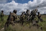 Ukrainian servicemen prepare to fire at Russian positions from a U.S.-supplied M777 howitzer in the Kharkiv region on July 14.