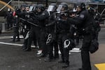 Portland police fire pepper spray, FN 303 plastic munitions, and aim a 40mm launcher while dispersing protesters from near the Justice Center an hour before the 8 p.m. curfew went into effect on May 30, 2020. The protests were against racist violence and police brutality in the wake of the Minneapolis police killing of George Floyd.