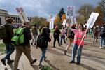 An OSU Coalition of Graduate Employees union member hands out picket signs to students taking part in a strike on Nov. 12, 2024.