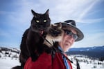 man on mt hood with two cats