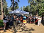 Community members gather at the Phoenix Library for a ribbon-cutting to celebrate the opening of the library's new pollinator garden.