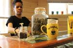 Portia Mittens, co-owner of Sumpter's second dispensary The Coughie Pot, shows off some of her products.