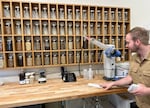 Seth O’Malley stands in front of a wall of botanical ingredients at the Wilderton distillery and tasting room in Hood River, Ore. on August 2, 2023.  The nonalcoholic spirit maker had to adapt all of the ingredients use to the capabilities of water as a solvent.