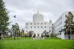 The Oregon Capitol sits behind the "Walk of Flags" in Salem, Oregon, Saturday, March 18, 2017.