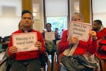 Members of the Leaven Community Land & Housing Coalition attend a Portland City Council Meeting on Thursday, Nov. 3, 2022, in Portland, Ore., to oppose a resolution that would ban street camping and create designated areas for homeless camping. The resolution has sparked fierce debate in the city.