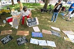 A attendee of the rally rearranges signs.