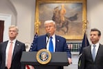President Donald Trump, center, answers a reporter's question as Dr. Mehmet Oz, administrator of the Centers for Medicare & Medicaid Services, left, and Food and Drug Administration Commissioner Martin Markary, right, listen during an event at the White House, May 12, 2025, in Washington.
