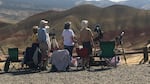 Visitors watch and photograph the eclipse in Oregon's Painted Hills.