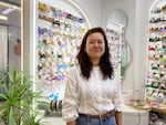 Nicole Zhang sells hair accessories at her storefront in the market.