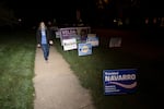 In this Tuesday, Sept. 15, 2020 file photo, transgender activist Sarah McBride, who hopes to win a seat in the Delaware Senate, walks next to campaign signs at Immanuel Church Highlands in Wilmington, Del. The run-up to the Nov. 3, 2020 general election has been a mix of excitement and apprehension for McBride, who has been a spokeswoman for the Human Rights Campaign for several years and is now running for a seat in the Delaware Senate.