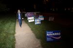 In this Tuesday, Sept. 15, 2020 file photo, transgender activist Sarah McBride, who hopes to win a seat in the Delaware Senate, walks next to campaign signs at Immanuel Church Highlands in Wilmington, Del. The run-up to the Nov. 3, 2020 general election has been a mix of excitement and apprehension for McBride, who has been a spokeswoman for the Human Rights Campaign for several years and is now running for a seat in the Delaware Senate.