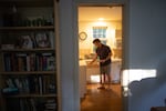 Gerhard du Plessis grabs a dinner plate while preparing to eat the Thai food he ordered for delivery.