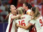 The Canadian women's soccer team celebrates during its win over Colombia Wednesday. The team has advanced into the Olympic quarterfinals amid an ongoing spying scandal involving the team's now-suspended head coach.
