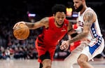 Portland guard Anfernee Simons, left, drives on Philadelphia forward Caleb Martin on Monday, Dec. 30, 2024, in Portland, Ore. Simons led the Trail Blazers with 25 points.