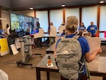 Blue Mountain Community College faculty union members and supporters hold up signs at Wednesday board meeting. The union is trying to convince the BMCC Board of Education not to cut faculty jobs. 