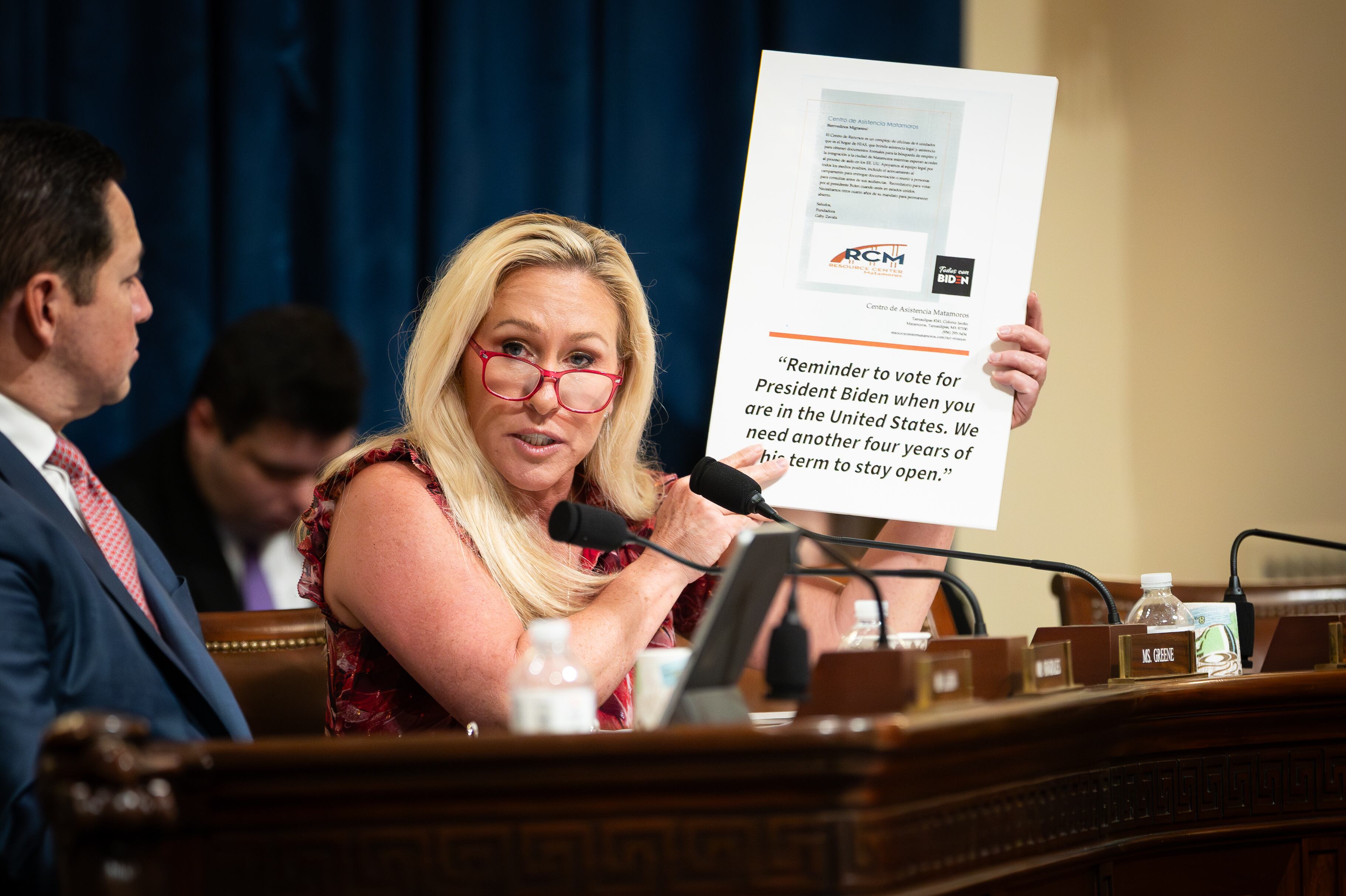 Rep. Marjorie Taylor Greene, R-Ga., holds a sign showing a screenshot of the viral flyer as Secretary of Homeland Security Alejandro Mayorkas testifies before the House Homeland Security Committee on April 16.