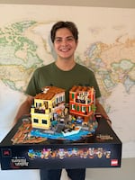 Alex Sahli is shown in this provided photo taken in July 2025 at his home in Portland posing with a LEGO set of the Italian Riviera that he designed and available to purchase starting in August 2025. Sahli designed the set, which has more than 3,200 pieces, in 2022 when he was a junior at Grant High School.