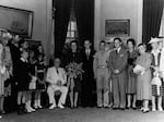 Louise Macy and Harry Hopkins were married in the Yellow Oval Room of the White House. President Franklin D. Roosevelt is seen seated next to the bride, holding her bouquet.