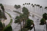 Motorists travel across the John Ringling Causeway in Sarasota, Fla., as Hurricane Ian churns to the south on Sept. 28, 2022.