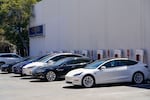 Electric vehicles can be seen charging at a shopping center in Emeryville, Calif., Wednesday, Aug. 10, 2022.
