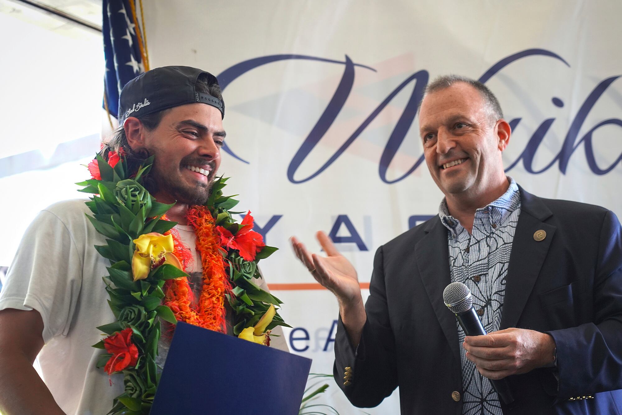 Hawaii Gov. Josh Green presents a proclamation to Oliver Widger.