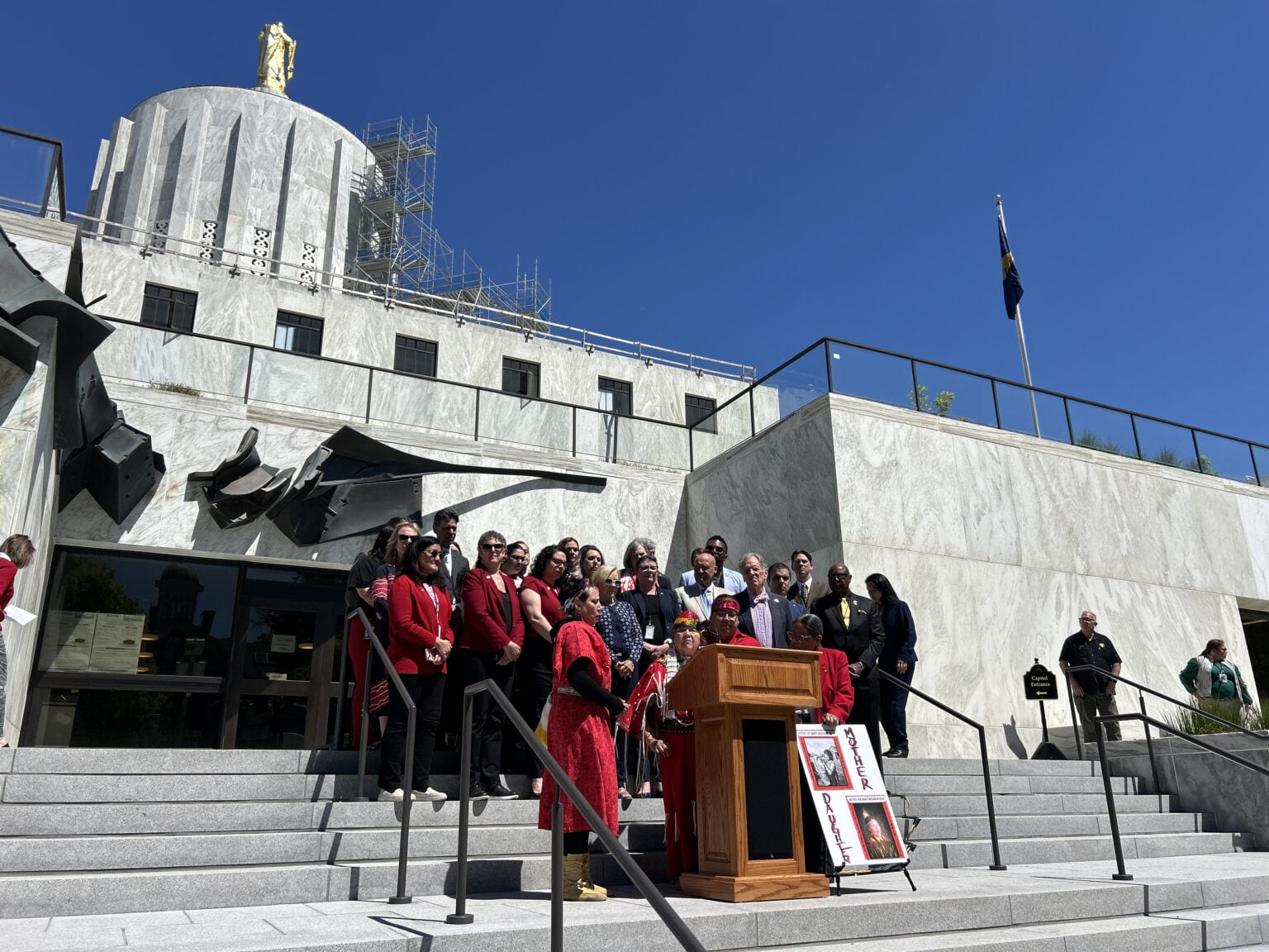 Rep. Tawna Sanchez, D-Portland, holds a sign and stands alongside fellow lawmakers and tribal leaders to acknowledge Missing and Murdered Indigenous Persons Day outside of the Oregon State Capitol in Salem on May 5, 2025.