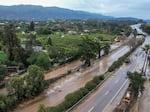 Water floods part of a road by the San Ysidro creek on Jameson Lane near the closed Highway 101 in Montecito, Calif., Jan. 10, 2023. Relentless storms from a series of atmospheric rivers have saturated the mountains and hillsides scarred from wildfires along much of California's coastline.