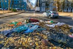 Litter and debris cover the middle of Southwest Main Street between Chapman and Lownsdale squares, Dec. 1, 2020 in Portland, Ore., where the David P. Thompson fountain and the bronze elk statue previously stood. The fountain and statue were both removed after being targeted by protesters.