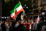 Demonstrators protesting the Islamic Republic regime in Iran gather as soccer fans walk toward the stadium ahead of the FIFA World Cup match between Egypt and Iran, on Friday, June 26, 2026, in Seattle.