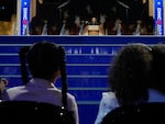 Vice President Kamala Harris speaks as her grand-nieces Amara Ajagu, left, and Leela Ajagu watch during the Democratic National Convention on Aug. 22, 2024, in Chicago.