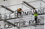 Workers construct scaffolding at the sign for the John F. Kennedy Center for the Performing Arts, Friday, June 12, 2026, in Washington.