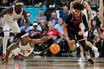 Oregon State forward Isaiah Sy (13) and Gonzaga guard Adam Miller (23) scramble for the ball during the first half of an NCAA college basketball semifinal game in the West Coast Conference men's tournament Monday, March 9, 2026, in Las Vegas.