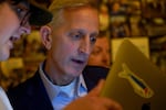 Portland Mayoral Candidate Keith Wilson, left, gets a look at initial returns from Cooper Bryant, senior policy communications advisor, at his election night party held at Old Town Brewing in Portland, Ore., Nov. 5, 2024.