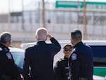 President Biden looks toward a large "Welcome to Mexico" sign that is hung over the Bridge of the Americas as he tours the port of entry in El Paso Texas on Jan. 8.