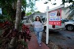 Krystal Guerra, 32, poses for a picture outside her apartment, which she has to leave after her new landlord gave her less than a month's notice that her rent would go up by 26%, Saturday, Feb. 12, 2022, in the Coral Way neighborhood of Miami. Guerra, who works in marketing while also pursuing a degree part-time, had already been spending nearly 50% of her monthly income on rent prior to the increase. Unable to afford a comparable apartment in the area as rents throughout the city have risen dramatically, Guerra is putting many of her belongings into storage and moving in with her boyfriend and his daughter for the time being.
