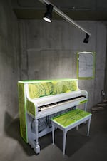 A fluorescent piano designed by artist Chet Malinow for for Piano. Push. Play.