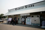 Community members walk to the T&T Country Store early in the morning on July 29, 2026 in Huntington Ore. The store became a hub for fire updates and resources.