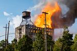 Firefighters and other emergency personnel monitor and battle a fire in downtown Portland, Ore., on Aug. 2, 2026. The fire was at an abandoned building on northwest Naito Parkway.