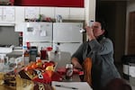 Melissa Cooper chugs an energy drink while planning the next meal. Cooper is in charge of sorting supplies, cooking, and setting up new arrivals with a place to sleep. "I'm tired. I'm getting four hours of sleep a night," she said.