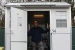 Ty Charnicky stands in the Pallet Shelter he moved into two weeks prior. Charnicky lauded the shelter, yet stressed the importance of having on-site supportive services.