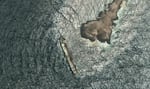 This satellite photo taken Wednesday Aug. 5, 2026, shows the tanker Caroline Bezengi, grounded and partly submerged off the coast of Oman, leaking crude oil into the sea.