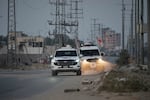 Red Cross vehicles carrying the bodies of people believed to be deceased hostages handed over by Hamas make their way toward the Kissufim border crossing with Israel, to be transferred to Israeli authorities, in Deir al-Balah, central Gaza Strip, on Thursday.