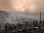 Rohingya refugees try to salvage their belongings after a major fire in the heavily cramped Balukhali camp.