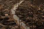 Thursday, Jan. 9: A person walks amid the destruction left by the Palisades Fire in the Pacific Palisades neighborhood of Los Angeles.