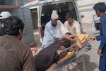 Rescue workers and volunteers transport an injured victim at a hospital after an overcrowded passenger bus plunged from a highway into a rocky ravine, in Dana Sar, a remote area near the border of Balochistan and Khyber Pakhtunkhwa provinces, in southwestern Pakistan, Friday, July 3, 2026.