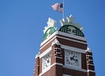 The U.S. flag flies above the Starbucks mermaid logo, Monday, April 26, 2021, at the coffee company's corporate headquarters in Seattle. The coffeemaking company confirms it has laid off more than 600 workers this week.