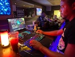 Nico Westley, 30, drinks raspberry hibiscus kratom tea while gaming at Kavasutra in Lantana, Fla. He says kratom makes him "feel more focused."