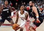Portland Trail Blazers guard Ja Morant drives the ball as Phoenix Suns guard and forward Dillon Brooks defends.